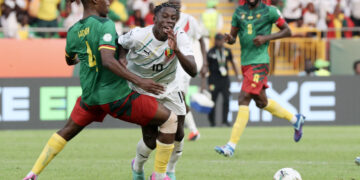Moriba Kourouma of Guinea  fouled by Christopher Maurice Wooh of Cameroon during the 2023 Africa Cup of Nations match between Cameroon and Guinea at Charles Konan Banny Stadium in Yamoussoukro, Cote dlvoire on 15 January 2024 ©Gavin Barker/BackpagePix
