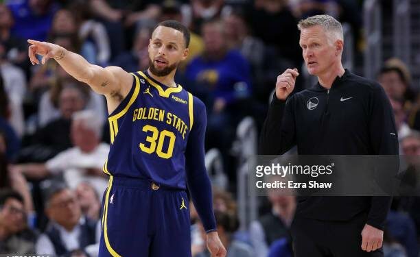SAN FRANCISCO, CALIFORNIA - APRIL 04: Stephen Curry #30 of the Golden State Warriors talks to head coach Steve Kerr during their game against the Oklahoma City Thunder in the second half at Chase Center on April 04, 2023 in San Francisco, California. NOTE TO USER: User expressly acknowledges and agrees that, by downloading and or using this photograph, User is consenting to the terms and conditions of the Getty Images License Agreement.  (Photo by Ezra Shaw/Getty Images)